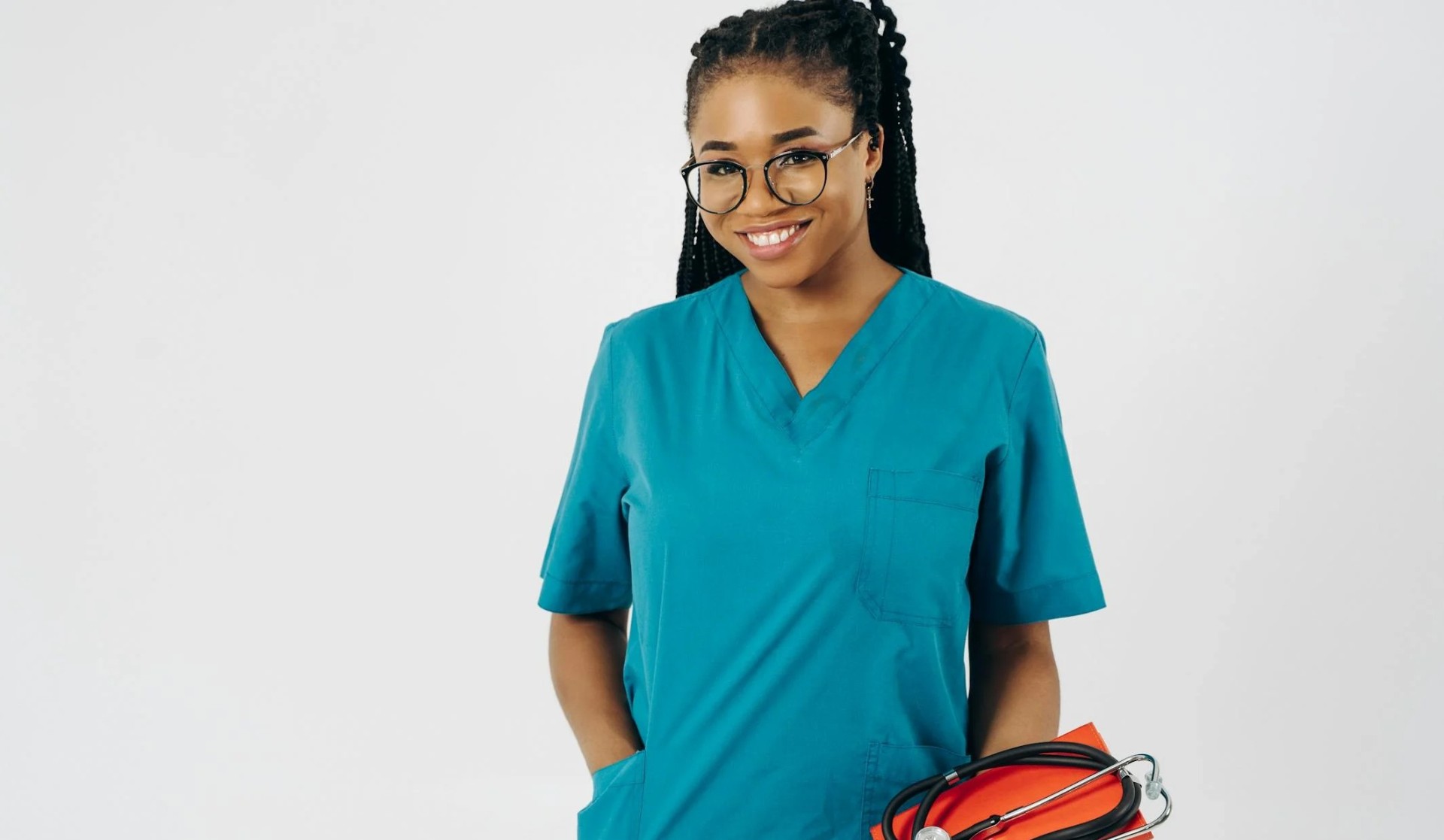 Healthcare professional smiling in teal scrubs